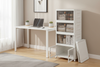 Stackable foldable storage bins neatly organized in a modern home office beside a white desk with natural lighting